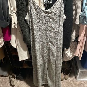 Maxi style bottom front sleeveless dress with tie front detail and slit.